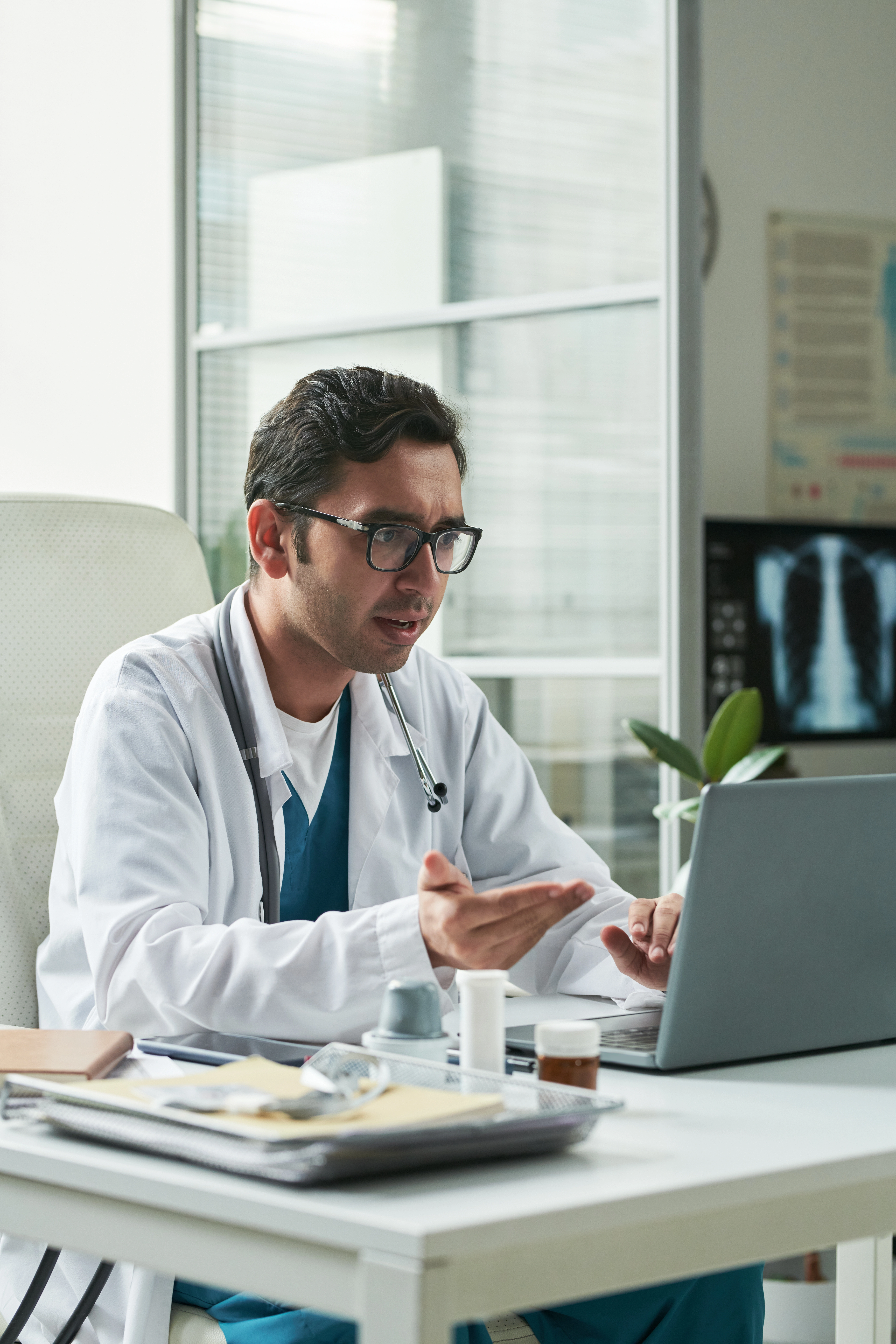 Medical billing specialist reviewing claims on a laptop